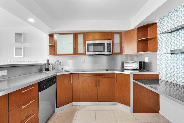 kitchen featuring open shelves, appliances with stainless steel finishes, light countertops, and glass insert cabinets