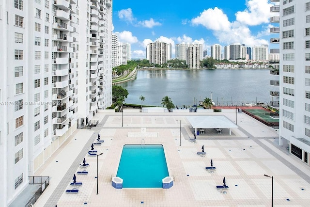 exterior space featuring a view of city, a patio, and a water view