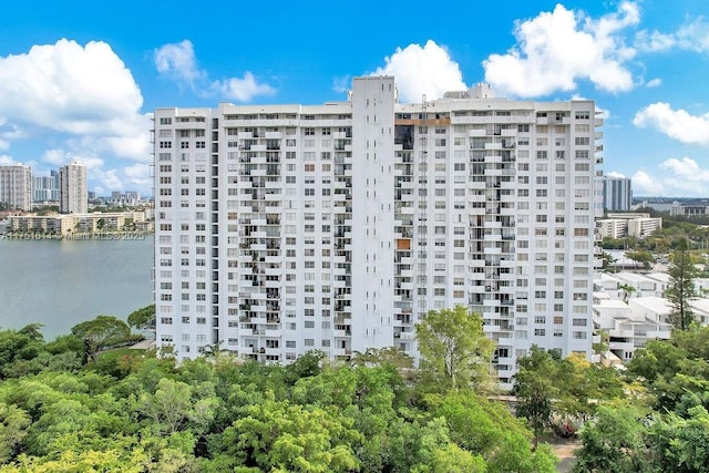 view of building exterior with a view of city and a water view