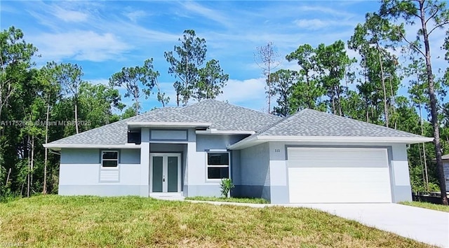 view of front facade featuring a garage, driveway, a shingled roof, french doors, and a front yard