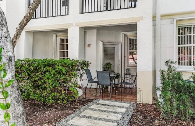 entrance to property featuring stucco siding