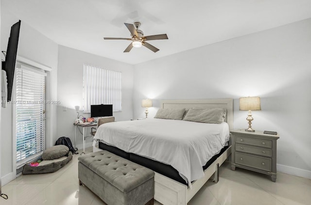 bedroom featuring light tile patterned floors, baseboards, and a ceiling fan