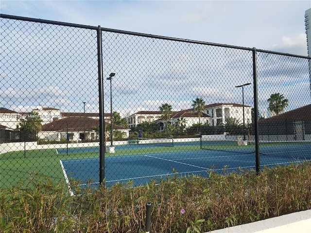 view of sport court with fence