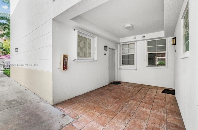 property entrance featuring a patio area and stucco siding