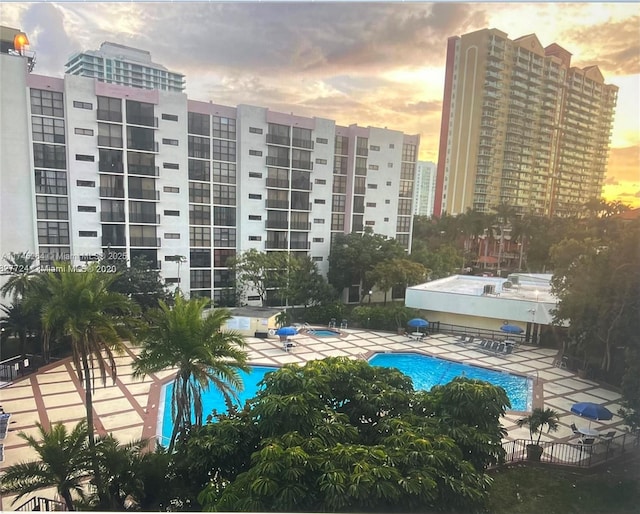 pool featuring a view of city and a patio area