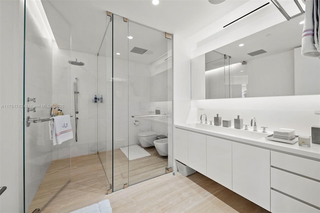 full bathroom featuring toilet, visible vents, a stall shower, double vanity, and a bidet