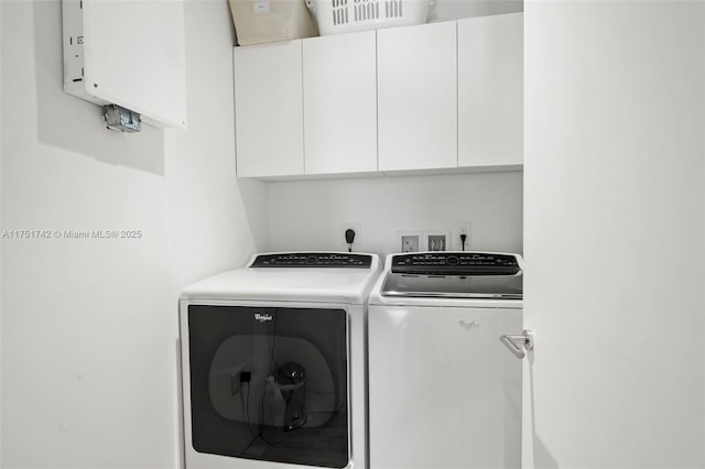 laundry area featuring washer and dryer and cabinet space