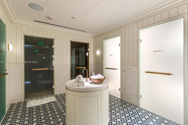 bathroom with tile patterned floors and crown molding