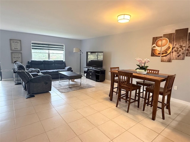 dining area with light tile patterned floors and baseboards