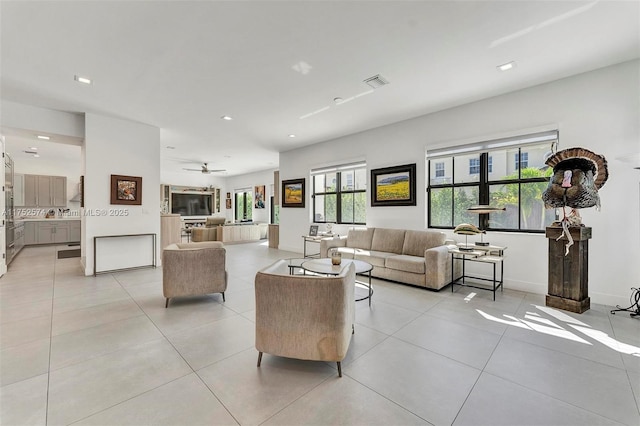 living area featuring recessed lighting, baseboards, visible vents, and light tile patterned flooring