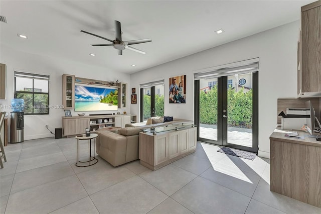 living area with a wealth of natural light, french doors, and recessed lighting