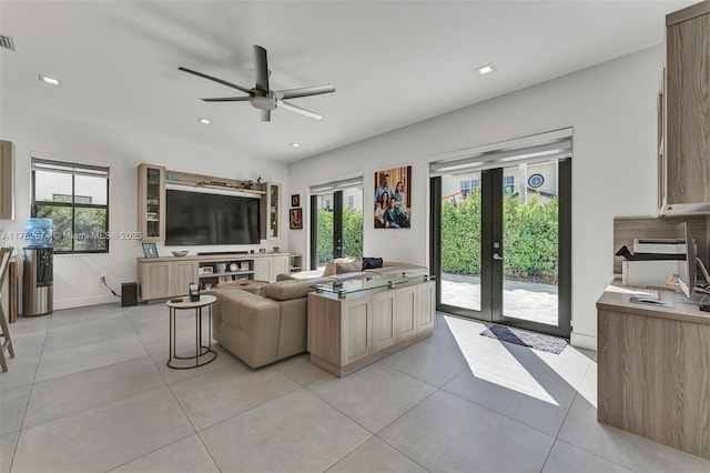 living area with light tile patterned floors, recessed lighting, and french doors