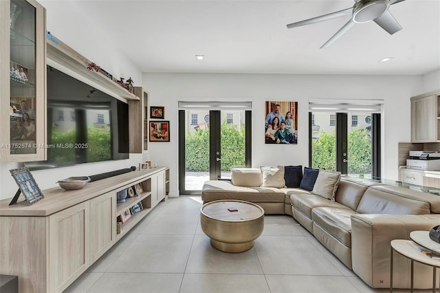 living area with light tile patterned floors, french doors, and a healthy amount of sunlight