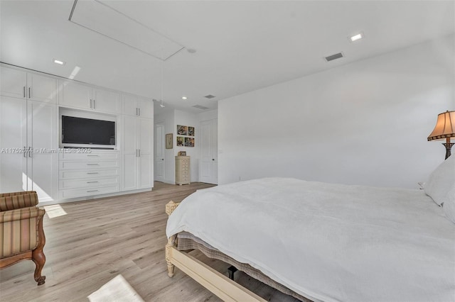 bedroom with visible vents, recessed lighting, attic access, and light wood-style floors