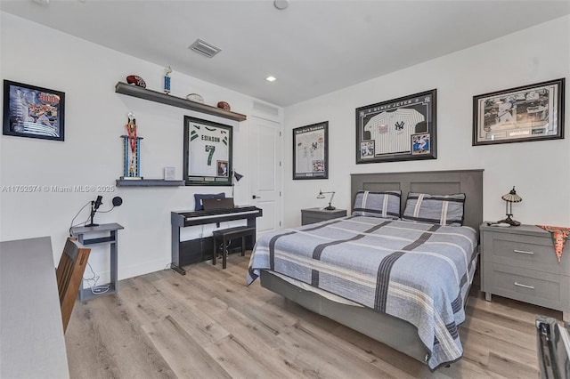 bedroom with baseboards, recessed lighting, visible vents, and light wood-style floors