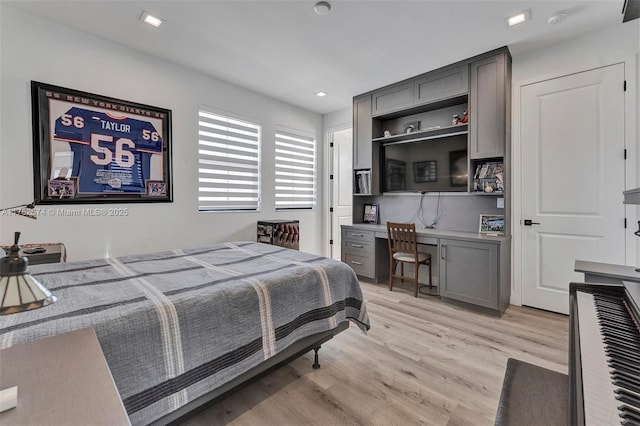 bedroom featuring light wood-style flooring, recessed lighting, and built in desk