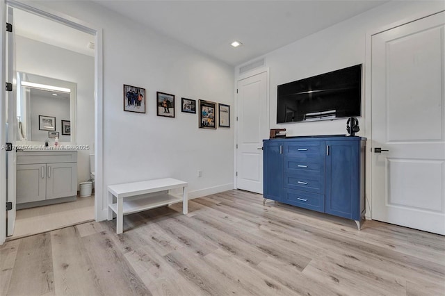 interior space with light wood finished floors and baseboards