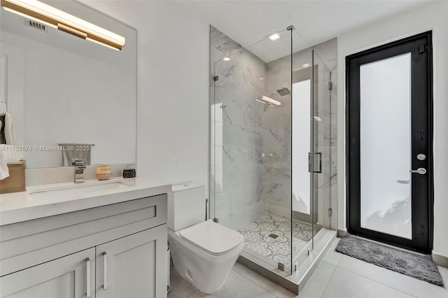 full bathroom featuring a marble finish shower, visible vents, toilet, vanity, and tile patterned floors