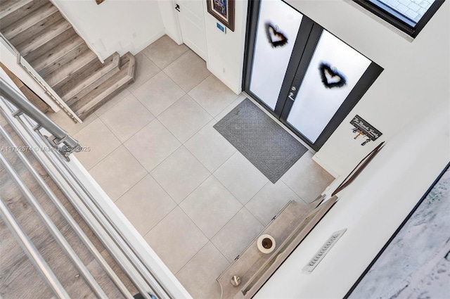 interior space featuring white cabinets and light tile patterned flooring