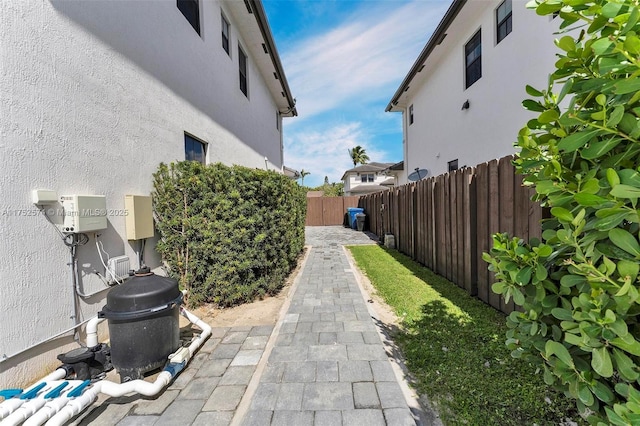 view of side of home with fence private yard and stucco siding