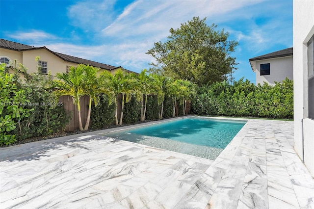 view of pool featuring fence and a patio