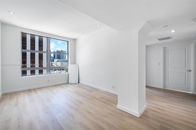 111 E Flagler St Unit 704, Miami, FL 33131 - empty room with light wood-style floors, recessed lighting, visible vents, and baseboards