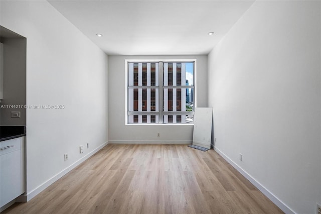 111 E Flagler St Unit 704, Miami, FL 33131 - empty room featuring recessed lighting, light wood-style flooring, and baseboards