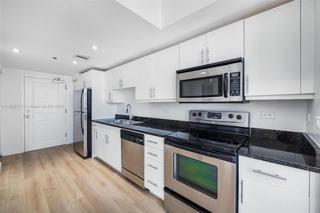 111 E Flagler St Unit 704, Miami, FL 33131 - kitchen with white cabinetry, stainless steel appliances, and a sink
