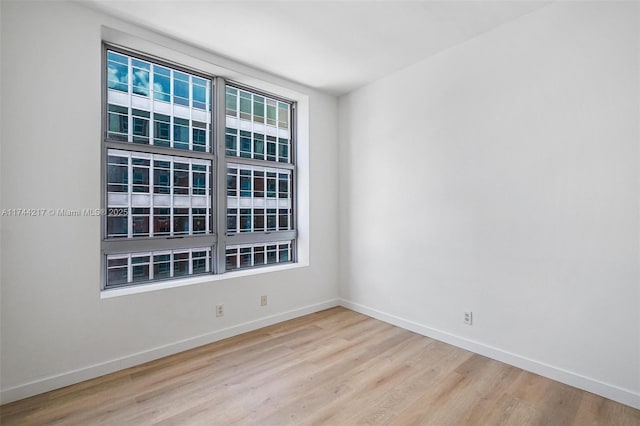 111 E Flagler St Unit 704, Miami, FL 33131 - empty room with light wood-style floors and baseboards