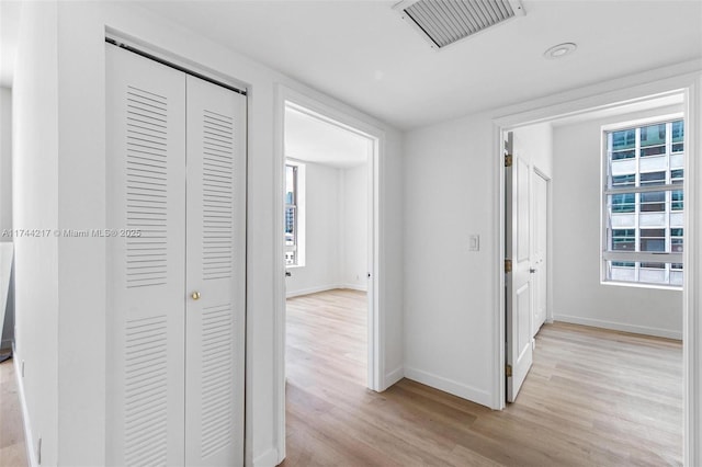 111 E Flagler St Unit 704, Miami, FL 33131 - hall with light wood-style floors, baseboards, and visible vents