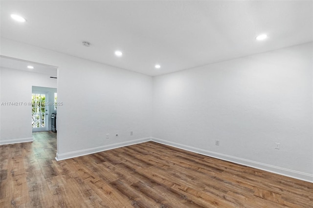 111 E Flagler St Unit 704, Miami, FL 33131 - spare room featuring baseboards, wood finished floors, and recessed lighting