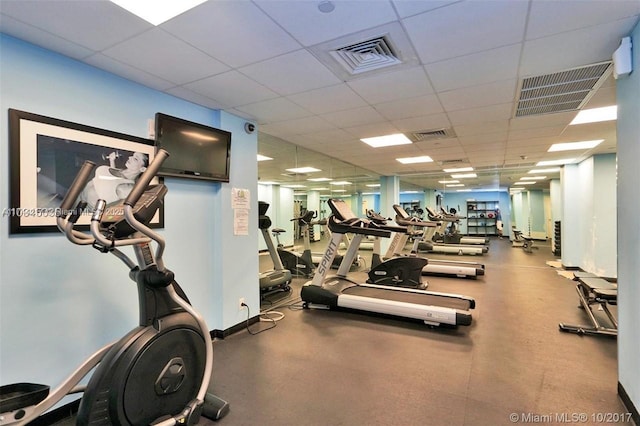 111 E Flagler St Unit 704, Miami, FL 33131 - workout area with a paneled ceiling, visible vents, and baseboards