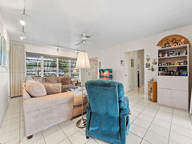 living room featuring rail lighting, light tile patterned flooring, and ceiling fan