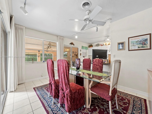 dining room with light tile patterned floors, rail lighting, and visible vents