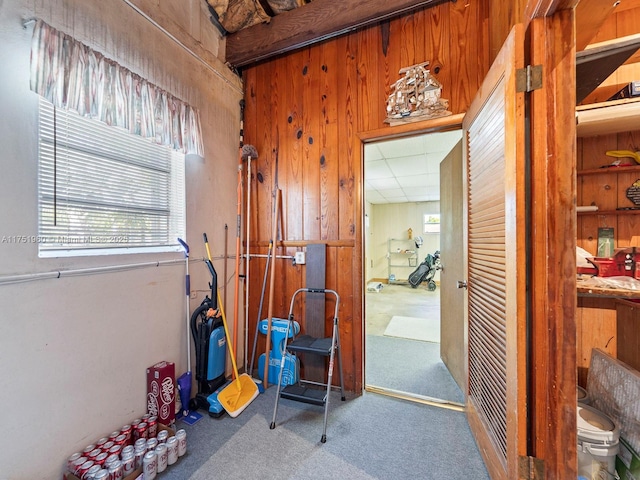 hall featuring a drop ceiling and carpet flooring