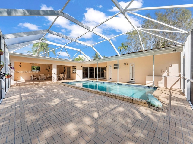 outdoor pool with a lanai and a patio