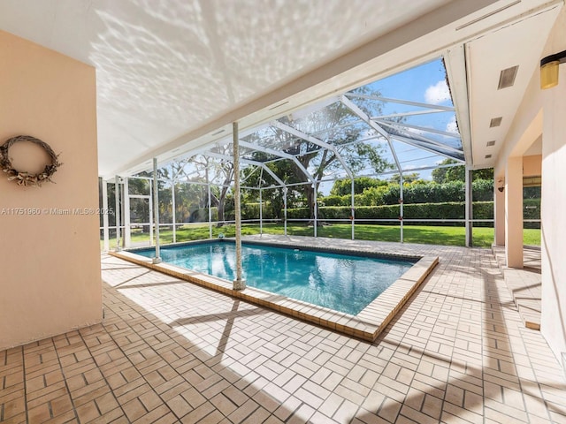 view of swimming pool featuring a patio, a lawn, glass enclosure, and a fenced in pool