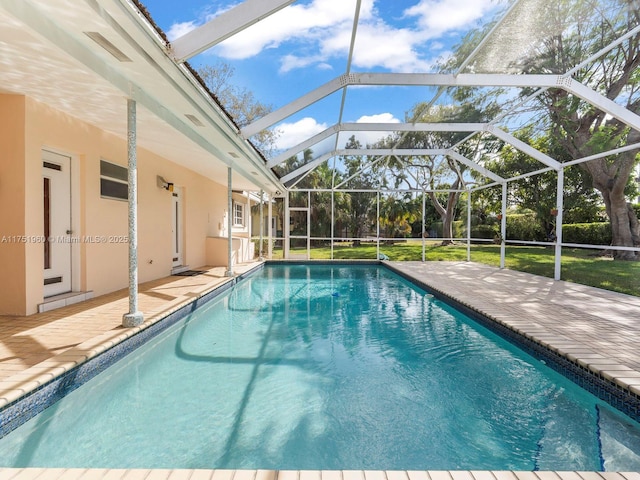 pool featuring a patio, a yard, and a lanai