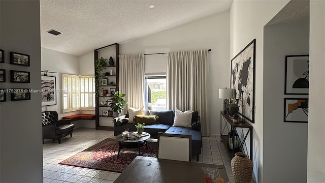 living area with lofted ceiling, visible vents, a textured ceiling, and light tile patterned flooring