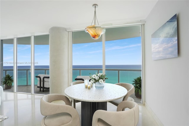 dining space with a wall of windows and a water view