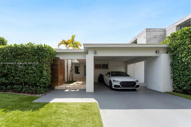 view of vehicle parking with driveway and a carport