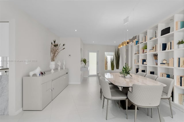 dining area with light tile patterned floors and baseboards