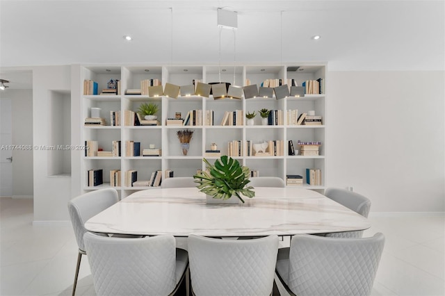 dining space featuring light tile patterned flooring and baseboards