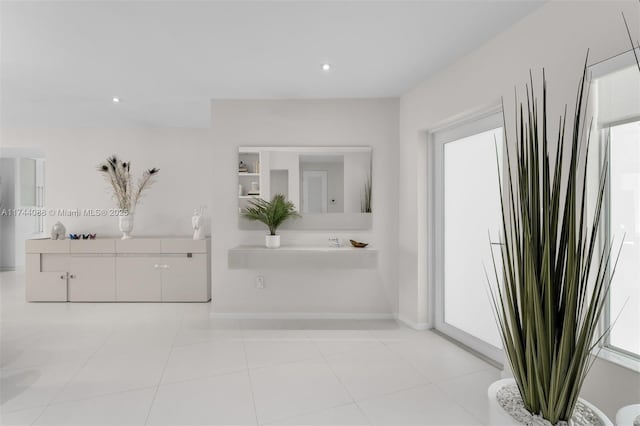 bathroom with tile patterned flooring, baseboards, and recessed lighting