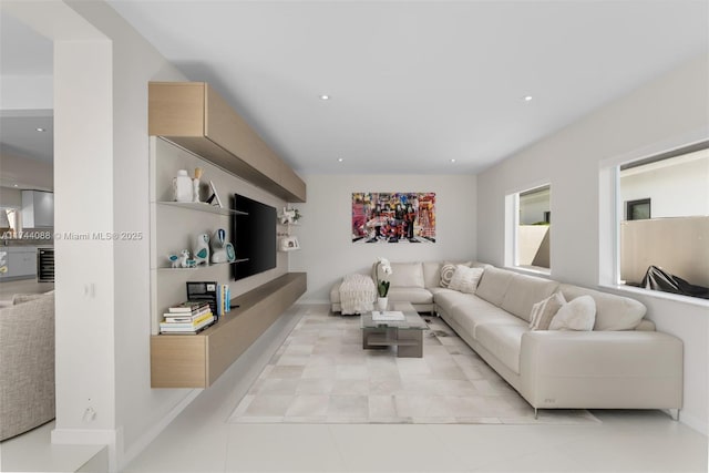 living room featuring baseboards and recessed lighting