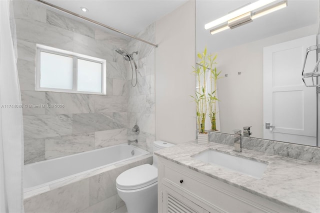 bathroom with toilet, vanity, and a combined bath / shower with marble appearance