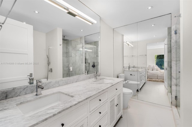 ensuite bathroom with connected bathroom, a sink, and a shower stall