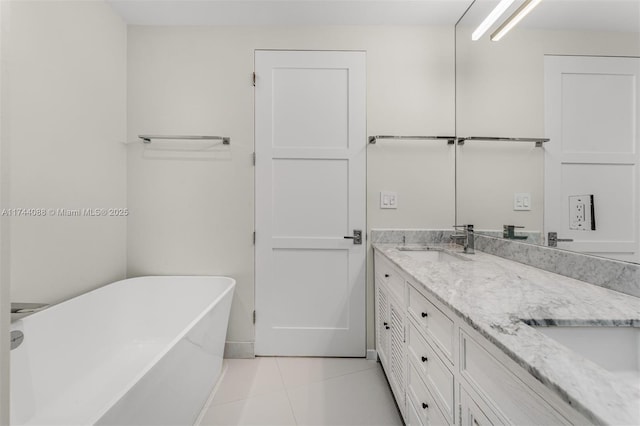 bathroom with double vanity, a soaking tub, tile patterned flooring, and a sink