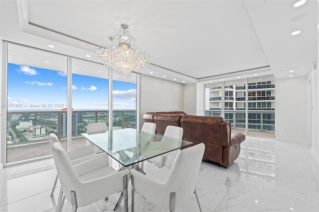 1830 S Ocean Dr Unit 3708, Hallandale Beach, FL 33009 - dining room featuring a wall of windows, a chandelier, a tray ceiling, recessed lighting, and light marble finish flooring