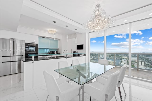 1830 S Ocean Dr Unit 3708, Hallandale Beach, FL 33009 - dining space featuring floor to ceiling windows, a chandelier, a tray ceiling, light marble finish floors, and recessed lighting
